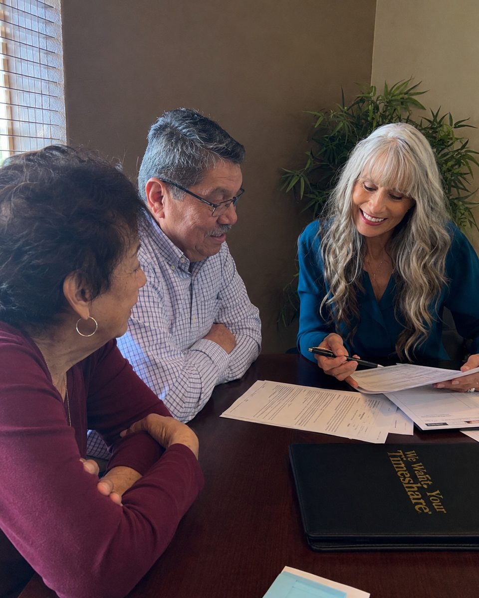 A timeshare professional meeting in person with a couple at the Phoenix office